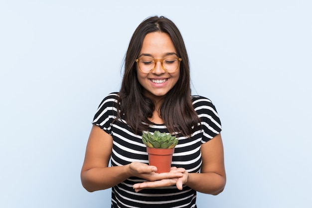 Young brunette woman holding a plant