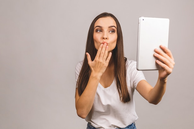 Young brunette woman holding tablet