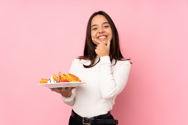 Young brunette woman holding waffles smiling