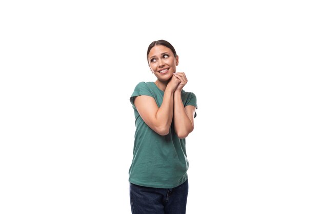 Young brunette woman in love with collected hair is dressed in a basic tshirt and jeans