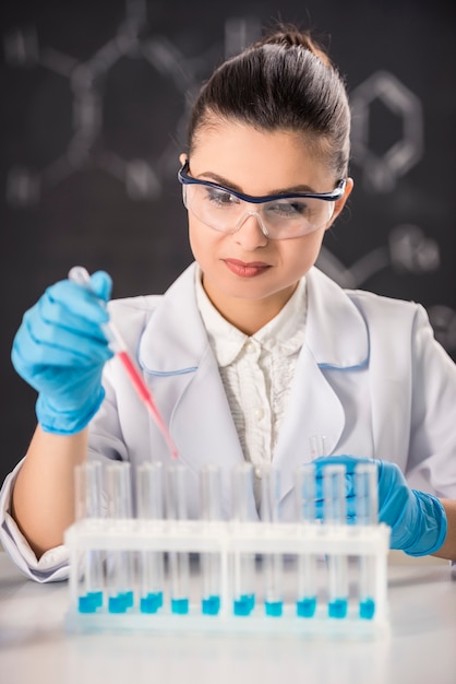 Young brunette woman scientist researcher in the laboratory.