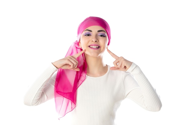 Young brunette woman wearing pink head scarf isolated