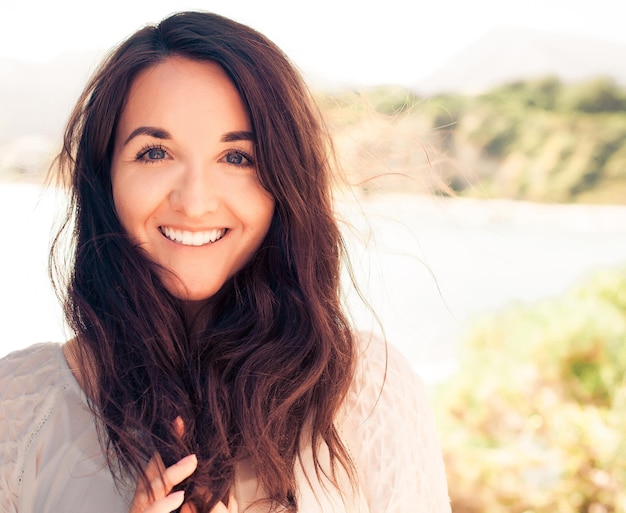 Young brunette woman in white dress. Happy summer time.