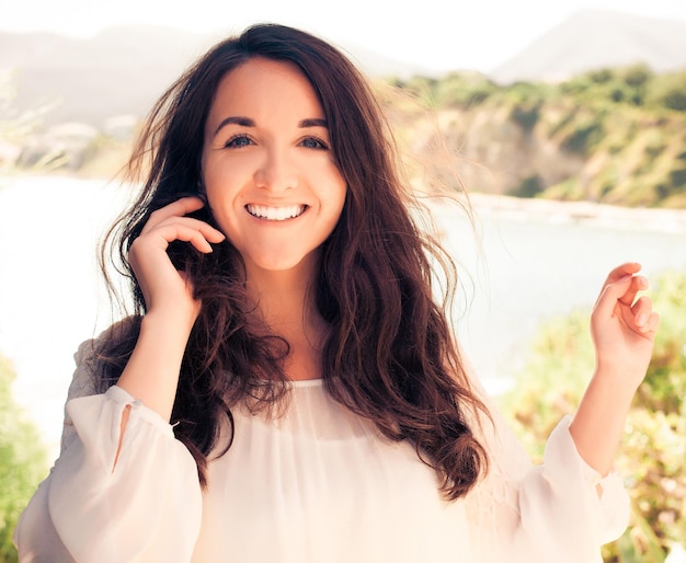 Young brunette woman in white dress. Happy summer time.