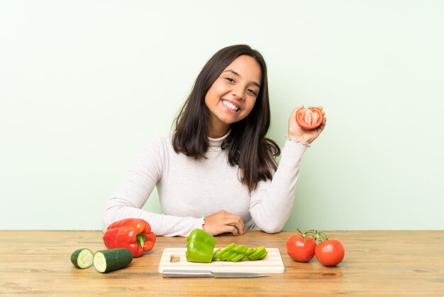 Young brunette woman with lots of vegetables