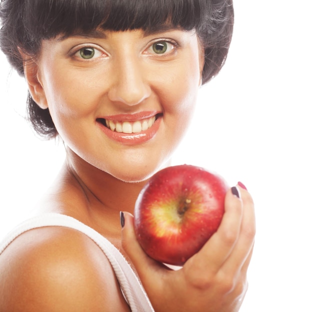 Young brunette woman with red apple