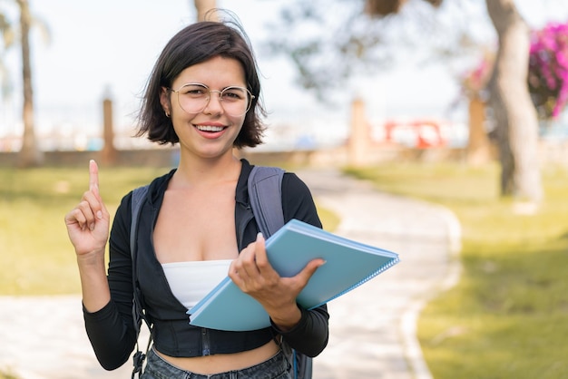 Young bulgarian student woman at outdoors pointing up a great idea