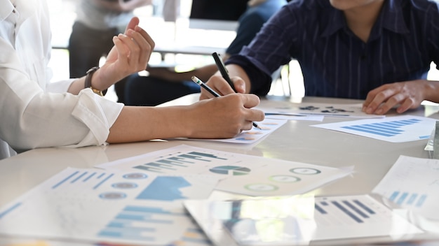 Young Business-adviseur die financiële cijfers analyseert en de voortgang aangeeft.