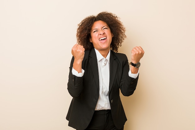 Young business african american woman cheering carefree and excited. Victory concept.