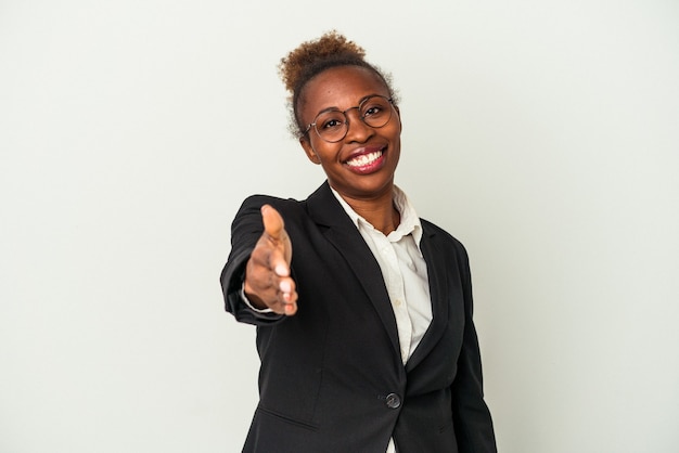 Young business african american woman isolated on white background stretching hand at camera in greeting gesture.