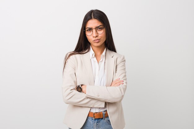 Young business arab woman isolated against a white background frowning face in displeasure, keeps arms folded.