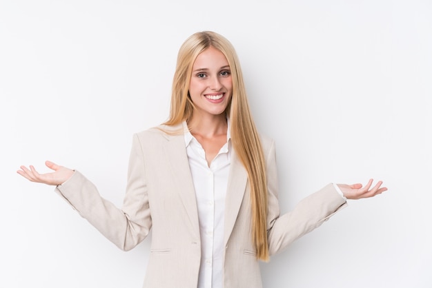 Young business blonde woman on white wall showing a welcome expression.