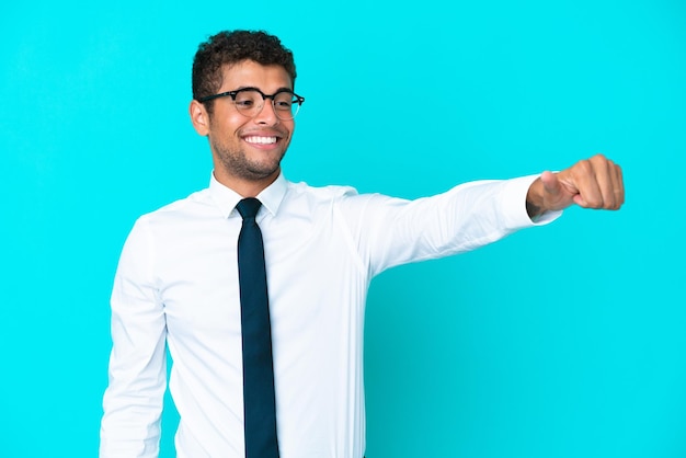 Young business brazilian man isolated on blue background giving a thumbs up gesture