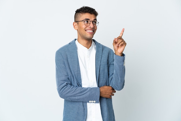 Young business Brazilian man isolated on white wall pointing up a great idea