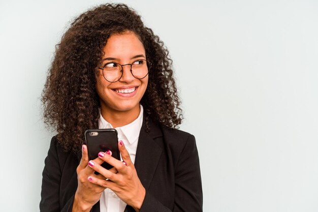 Young business Brazilian woman holding mobile phone isolated on white background