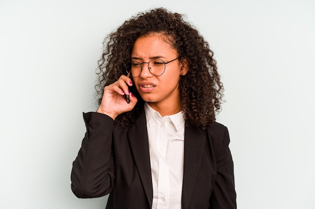 Young business Brazilian woman holding mobile phone isolated on white background