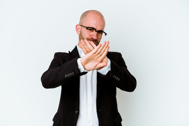 Young business caucasian bald man isolated on blue background doing a denial gesture