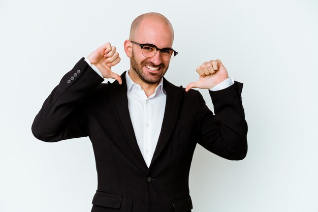 Young business caucasian bald man isolated on blue wall feels proud and self confident, example to follow