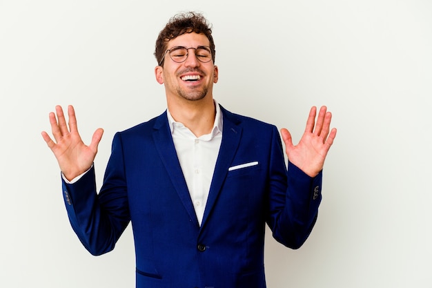 Young business caucasian man isolated on white background laughs out loudly keeping hand on chest.