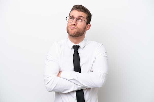 Young business caucasian man isolated on white background making doubts gesture while lifting the shoulders