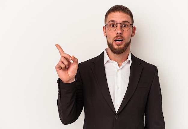 Young business caucasian man isolated on white background pointing to the side