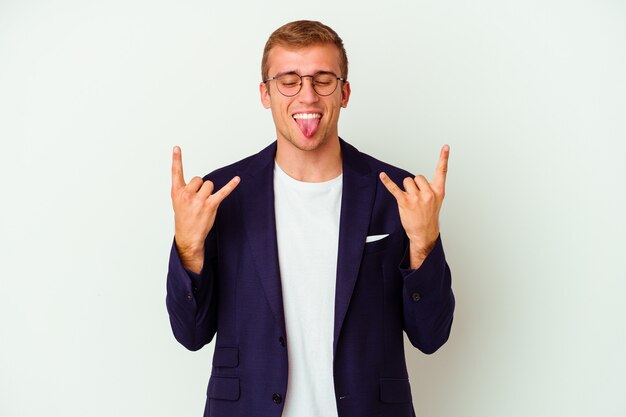 Young business caucasian man isolated on white background showing rock gesture with fingers