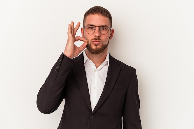 Young business caucasian man isolated on white background with fingers on lips keeping a secret.