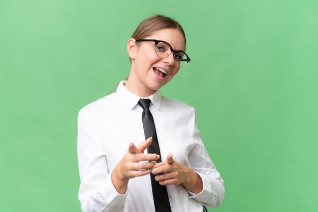 Young business caucasian woman over isolated background pointing to the front and smiling