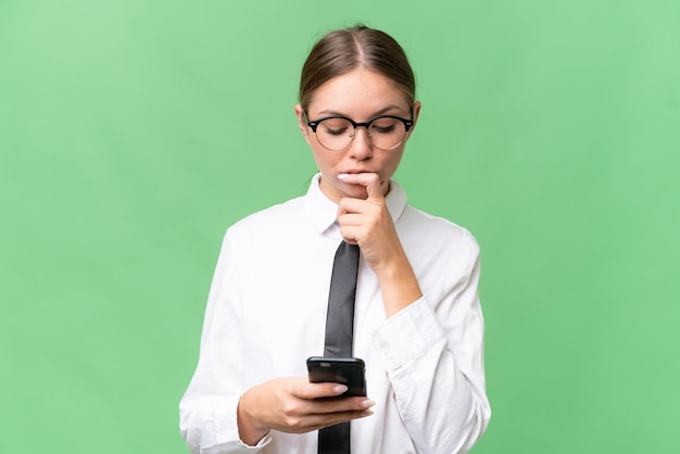 Young business caucasian woman over isolated background thinking and sending a message