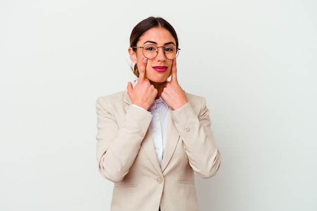 Young business caucasian woman isolated on white background doubting between two options.