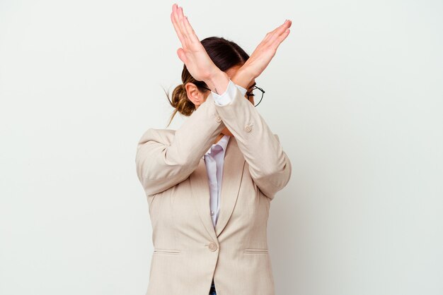 Young business caucasian woman isolated on white background keeping two arms crossed, denial concept.