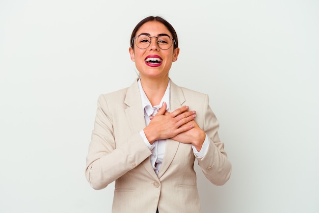 Young business caucasian woman isolated on white background laughing keeping hands on heart, concept of happiness.