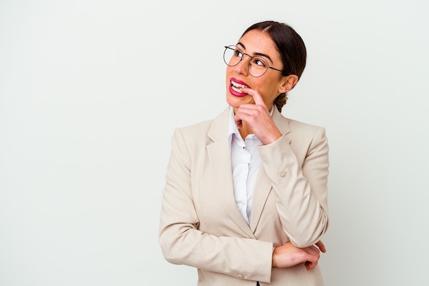 Young business caucasian woman isolated on white background relaxed thinking about something looking at a copy space.