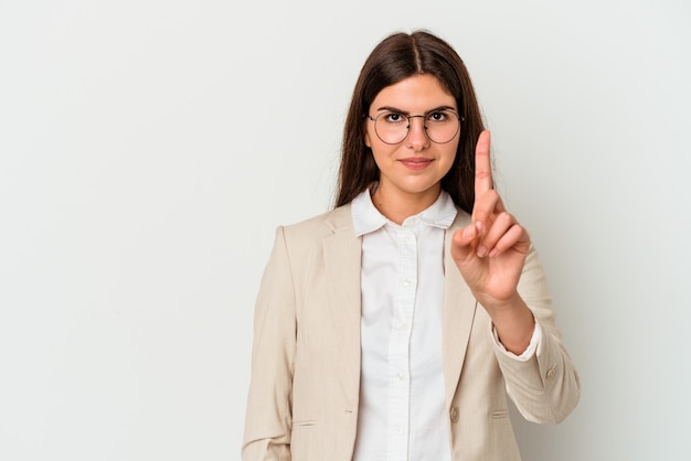 Young business caucasian woman isolated on white background showing number one with finger.