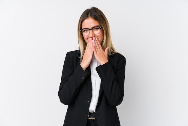 Young business caucasian woman laughing about something, covering mouth with hands.