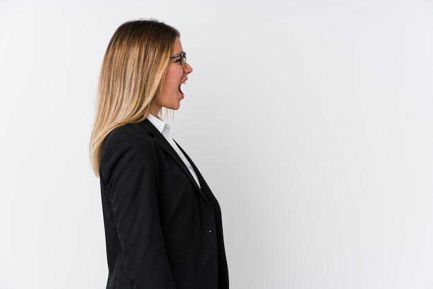 Young business caucasian woman shouting towards a copy space