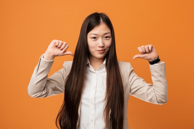 Young business chinese woman feels proud and self confident, example to follow.