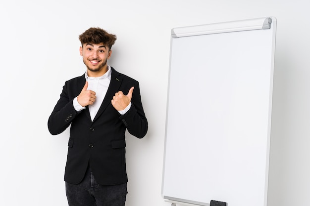 Young business coaching arab man raising both thumbs up, smiling and confident.