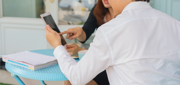 Young business couple are using tablet