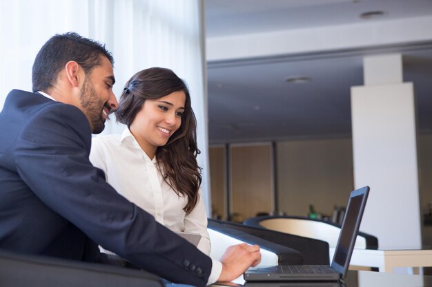 Young Business Couple Meeting With Tech Devices