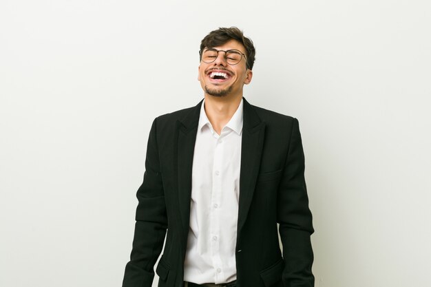 Young business hispanic man relaxed and happy laughing, neck stretched showing teeth