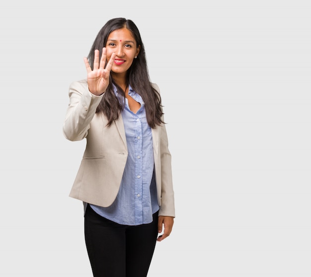 Young business indian woman showing the number four