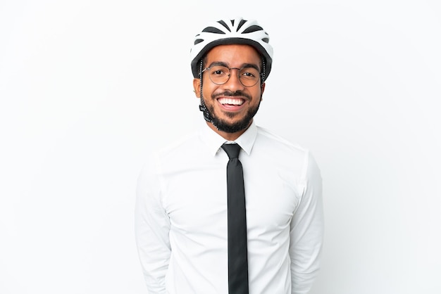 Young business latin man holding a bike helmet isolated on white background with glasses and happy