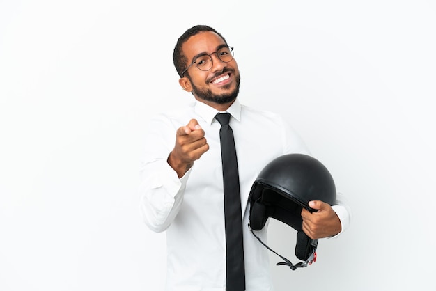 Young business latin man with a motorcycle helmet isolated on white background pointing front with happy expression