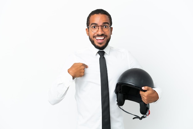 Young business latin man with a motorcycle helmet isolated on white background with surprise facial expression