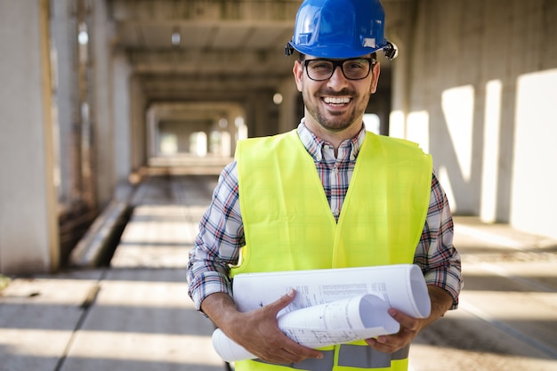 Young business man construction site engineer with blue print