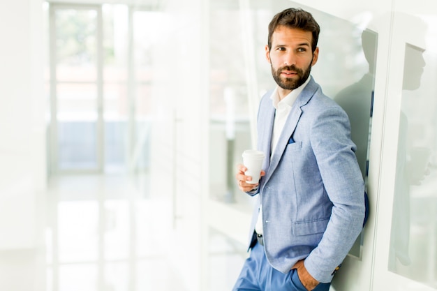 Young business man drinking coffee on break