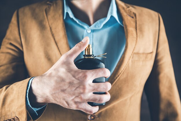 Young business man hand perfume