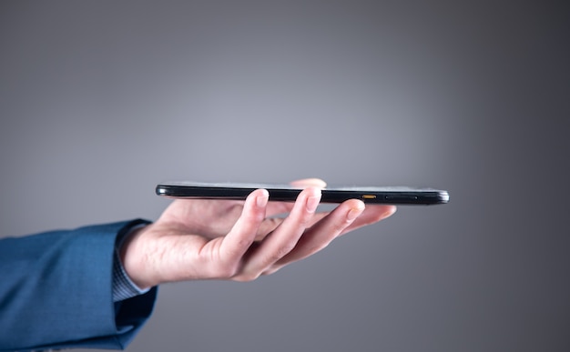 Young business man holding smart phone.