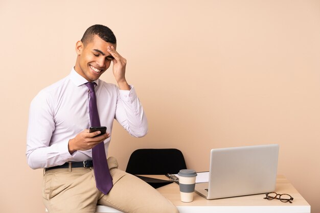 Young business man in a office laughing